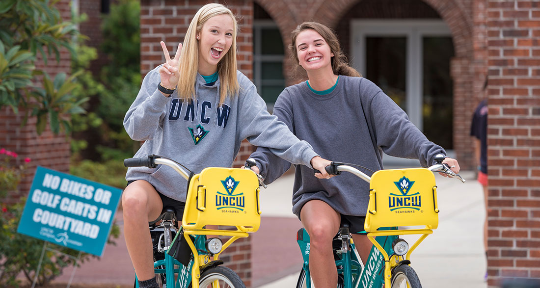 Students riding bikes on campus